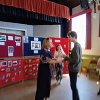 Bev Snowden presenting prize to
                              Matthew Steel. organiser Katie Simkins
                              watching