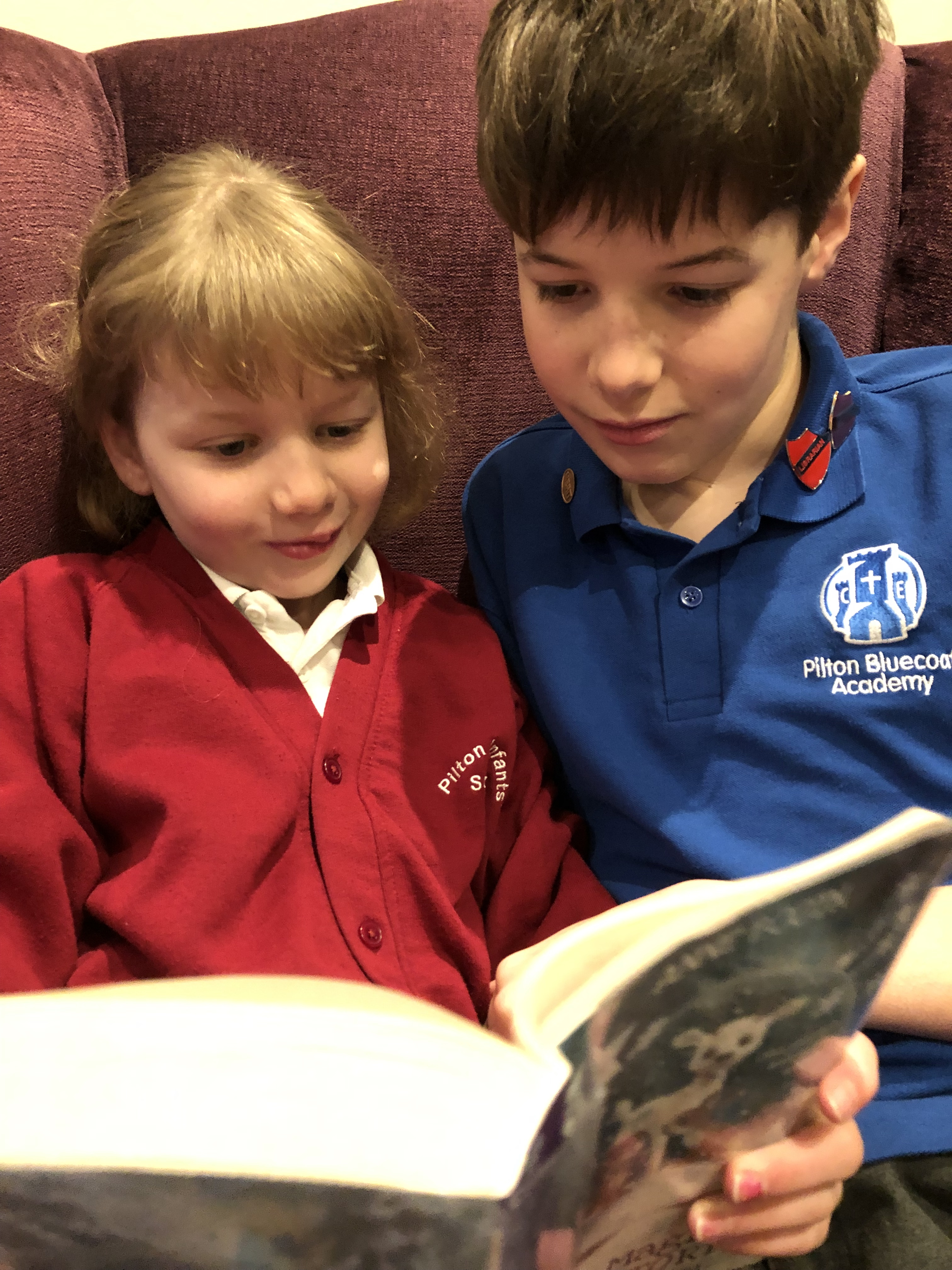 Alex Meller reading to his sister
                                  Lucy